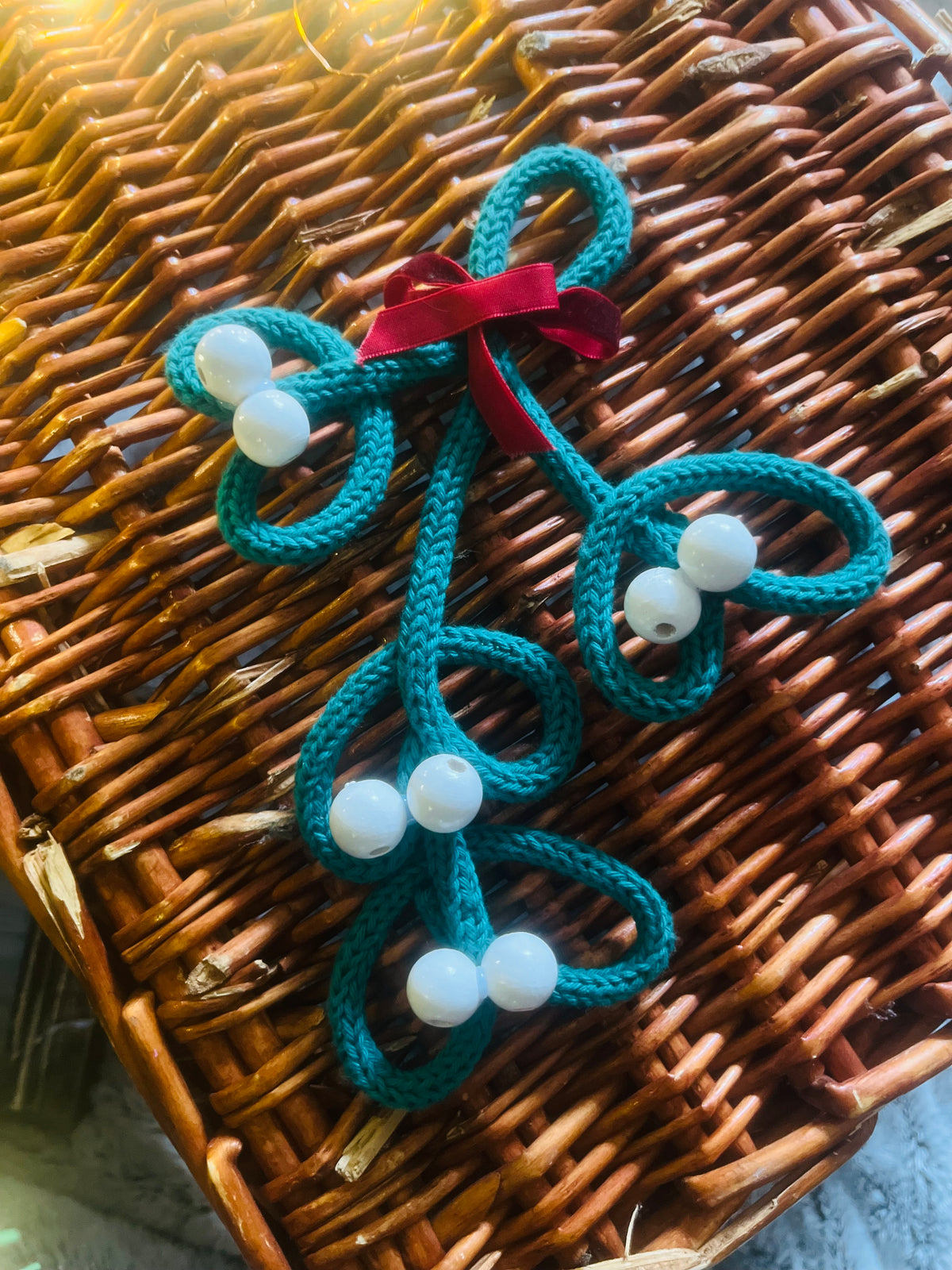 Handmade knitted wire mistletoe Christmas decoration with wooden beads and burgundy velvet ribbon
